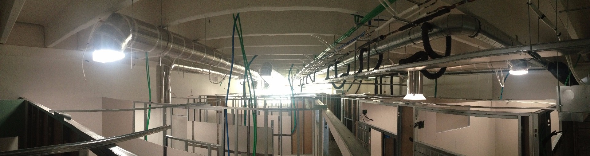 Above-ceiling shot showing installed daylighting system tubing