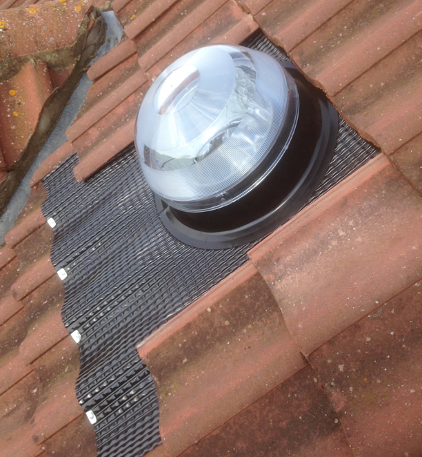 Installed profiled and interlocking tile roof flashing