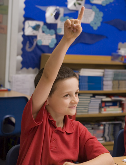 Child raising hand in class